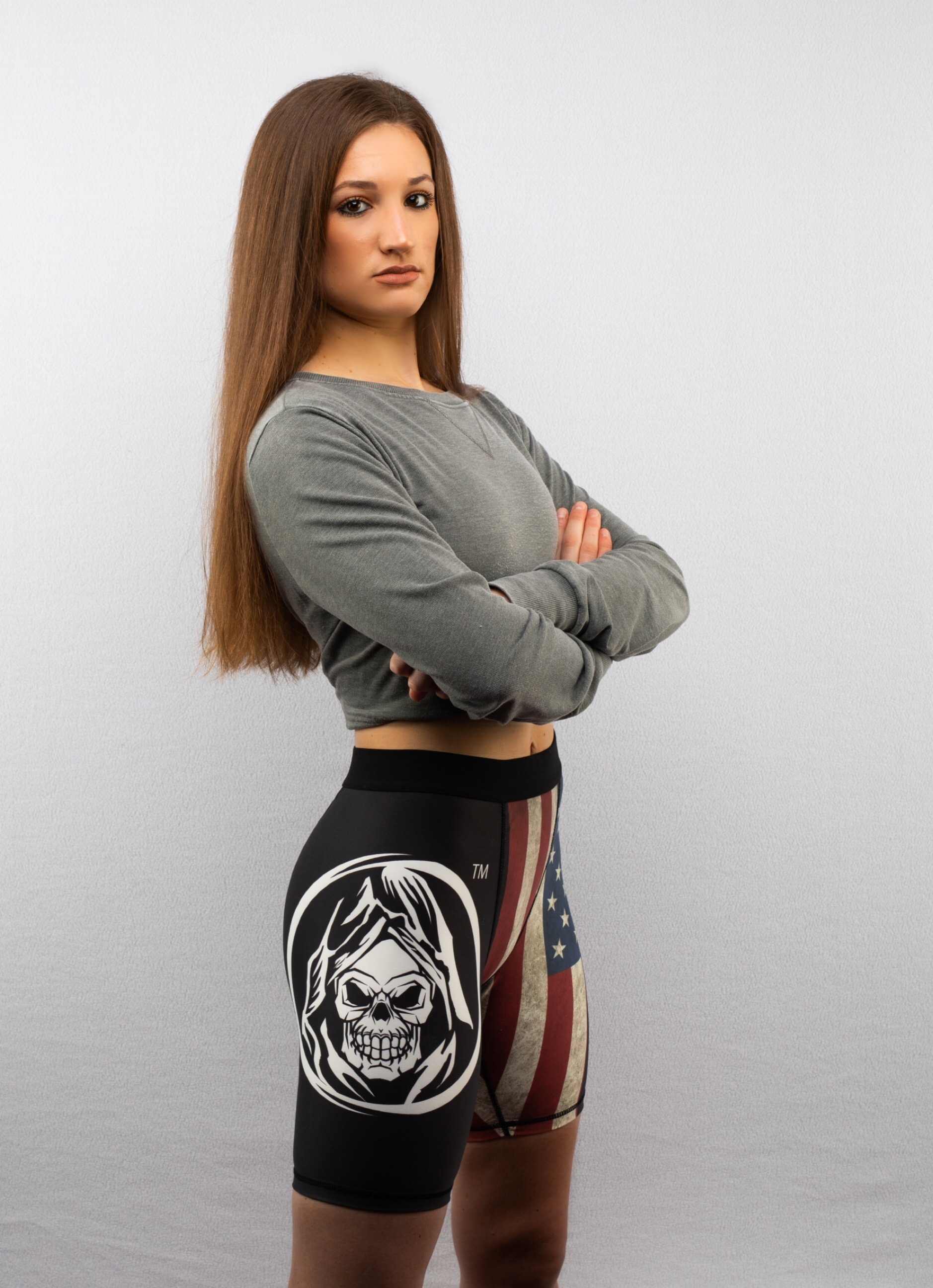 Brianna Kristin standing confidently, arms crossed, wearing training gear.