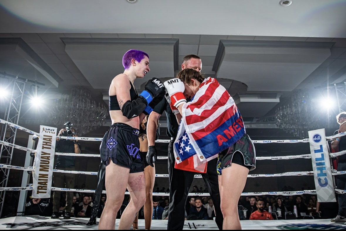 Brianna Kristin wrapped in the American flag in the boxing ring corner