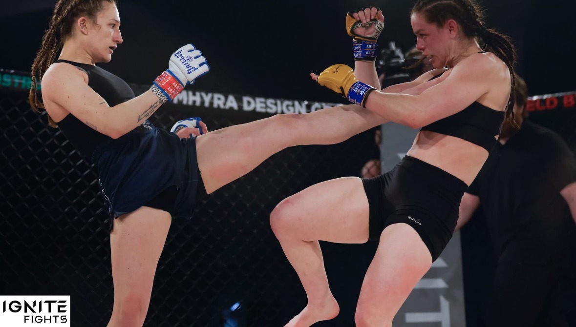 Brianna Kristin throwing a kick in an MMA cage fight