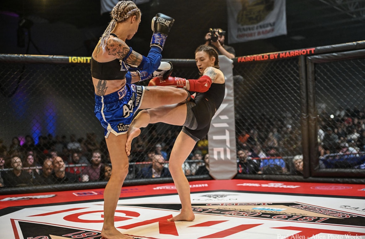 Brianna Kristin throwing a kick in an MMA cage fight
