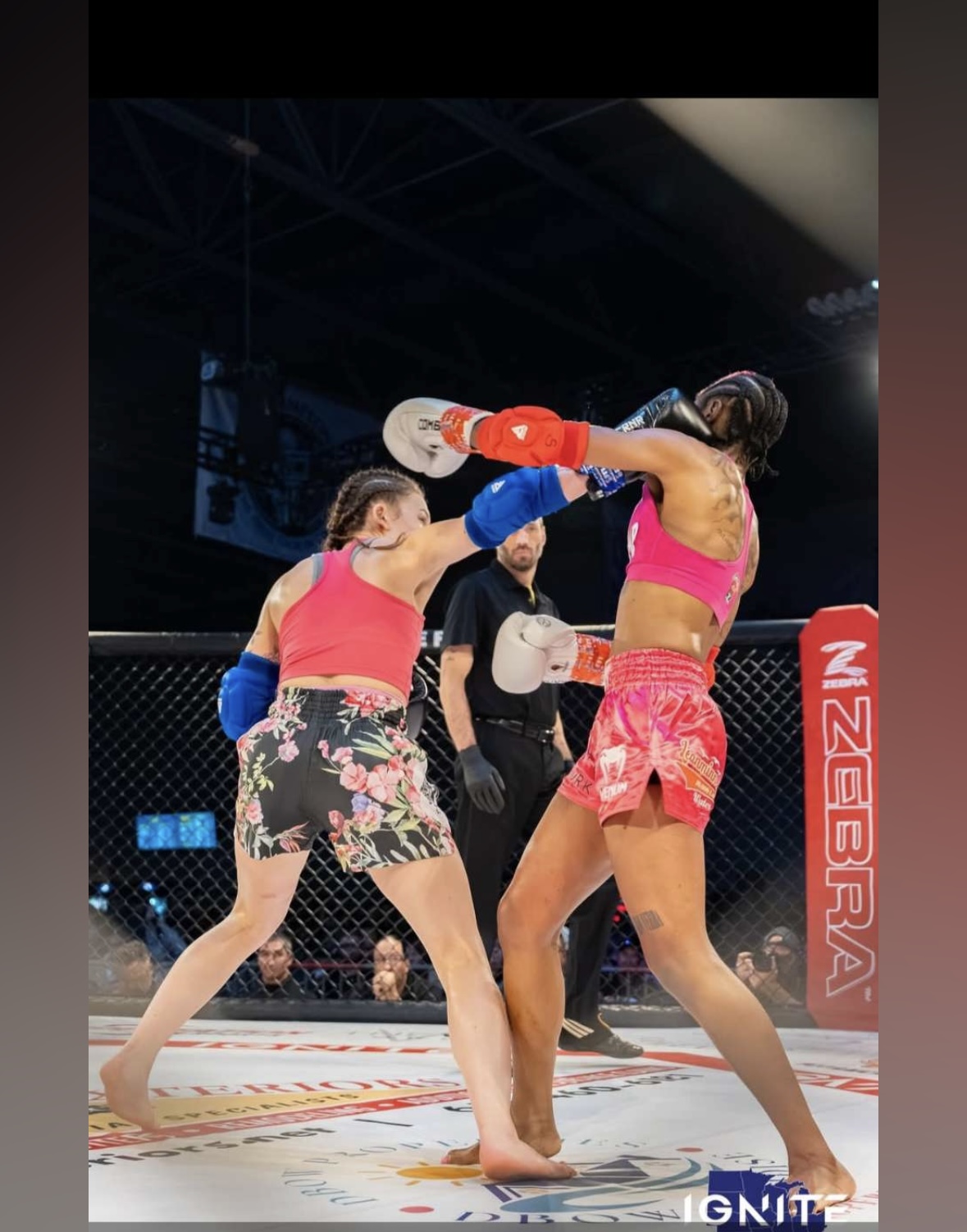 Brianna Kristin landing a punch in an MMA cage fight