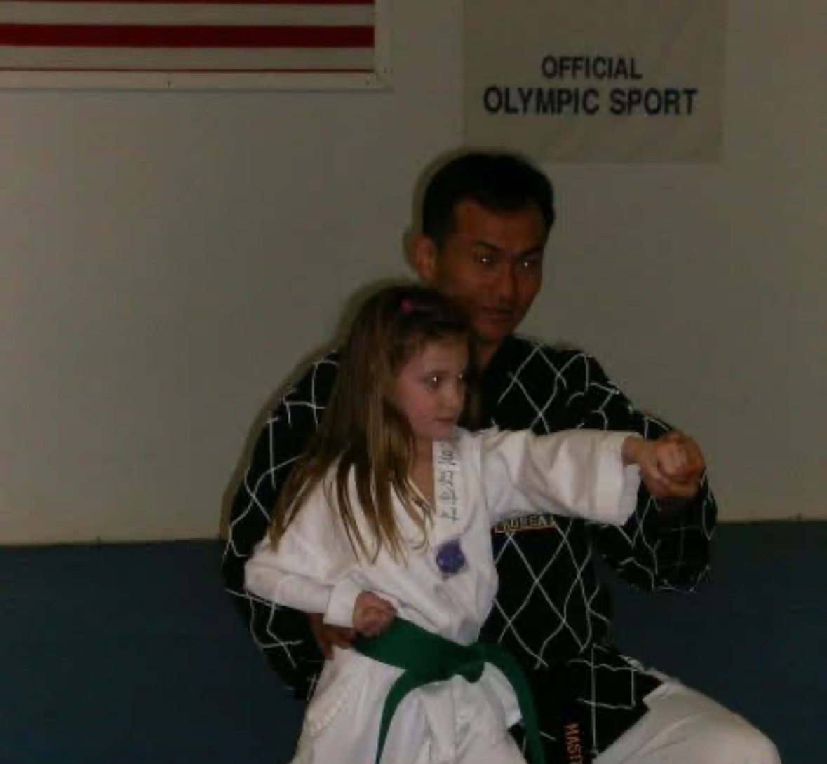 Young Brianna Kristin throwing a punch with her Taekwondo instructor