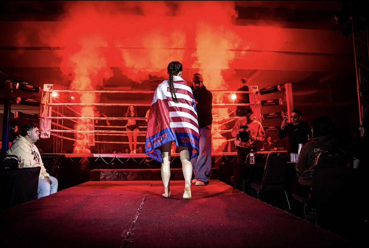 Brianna Kristin walking out to the ring wrapped in the American flag