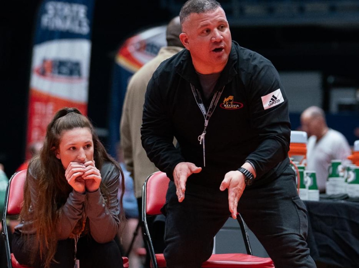 Brianna Kristin coaching from the sideline at a wrestling tournament